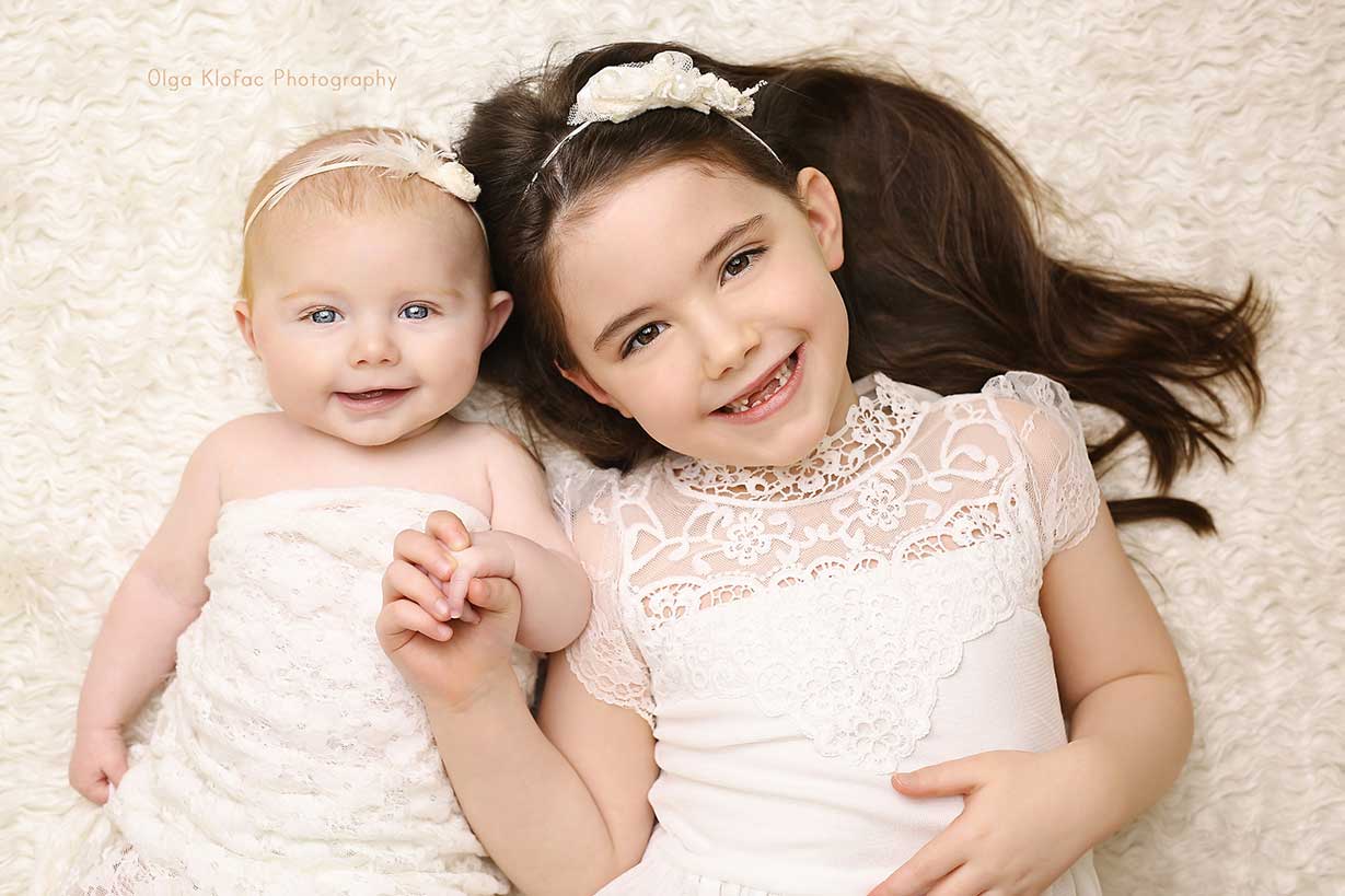 family photo of a girl with her baby sister by prfessional baby photographer Mayo Sligo Galway